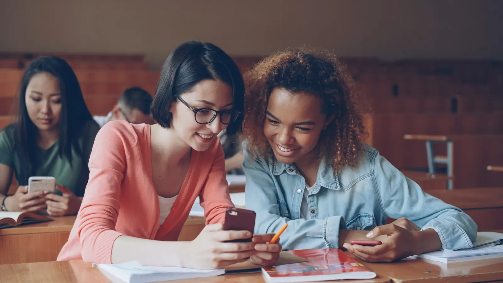 Studierende mit Smartphones im Hörsaal